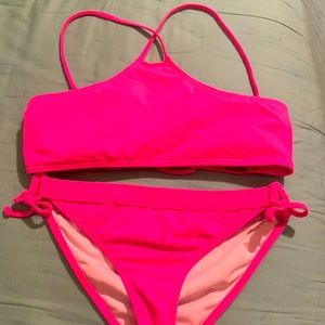 This is a girls size L billabong bikini swimsuit set that is hot pink